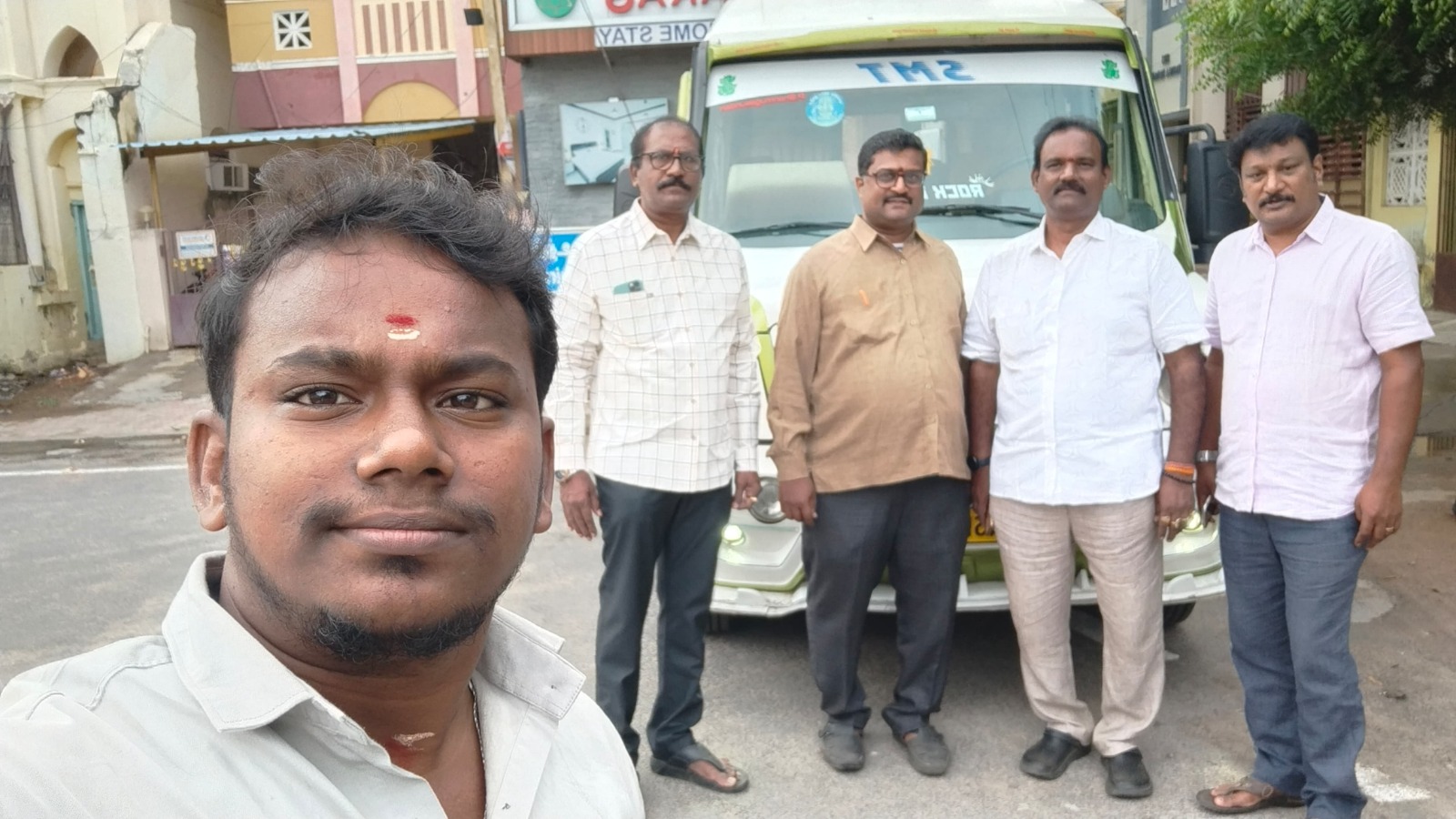 Group ready to depart in tempo traveller